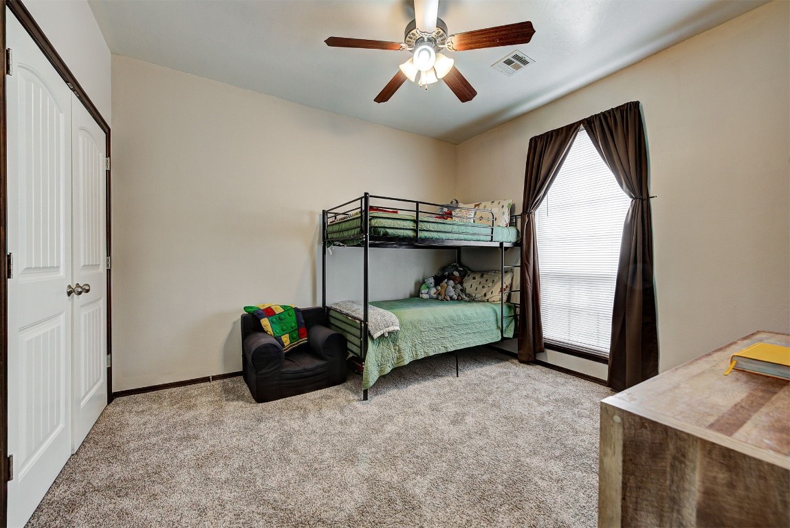 820 White Tail Court, Guthrie, OK 73044 bedroom featuring ceiling fan and carpet flooring
