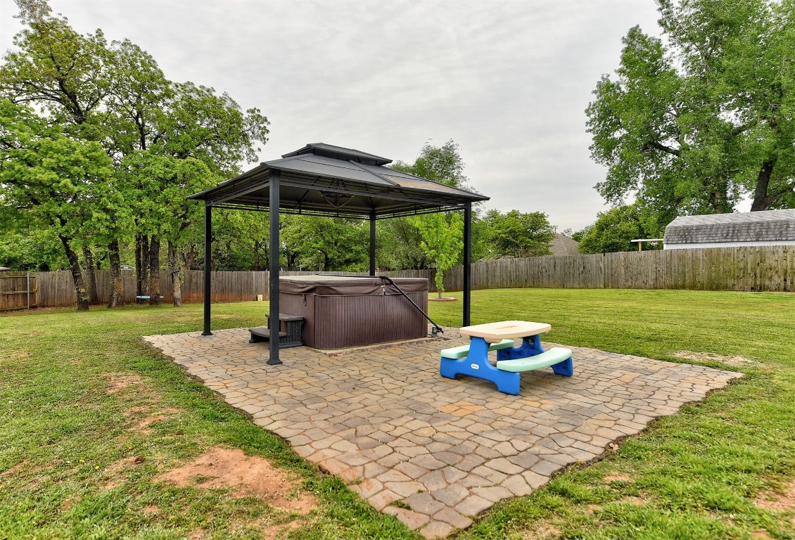 820 White Tail Court, Guthrie, OK 73044 view of terrace featuring a hot tub and a gazebo