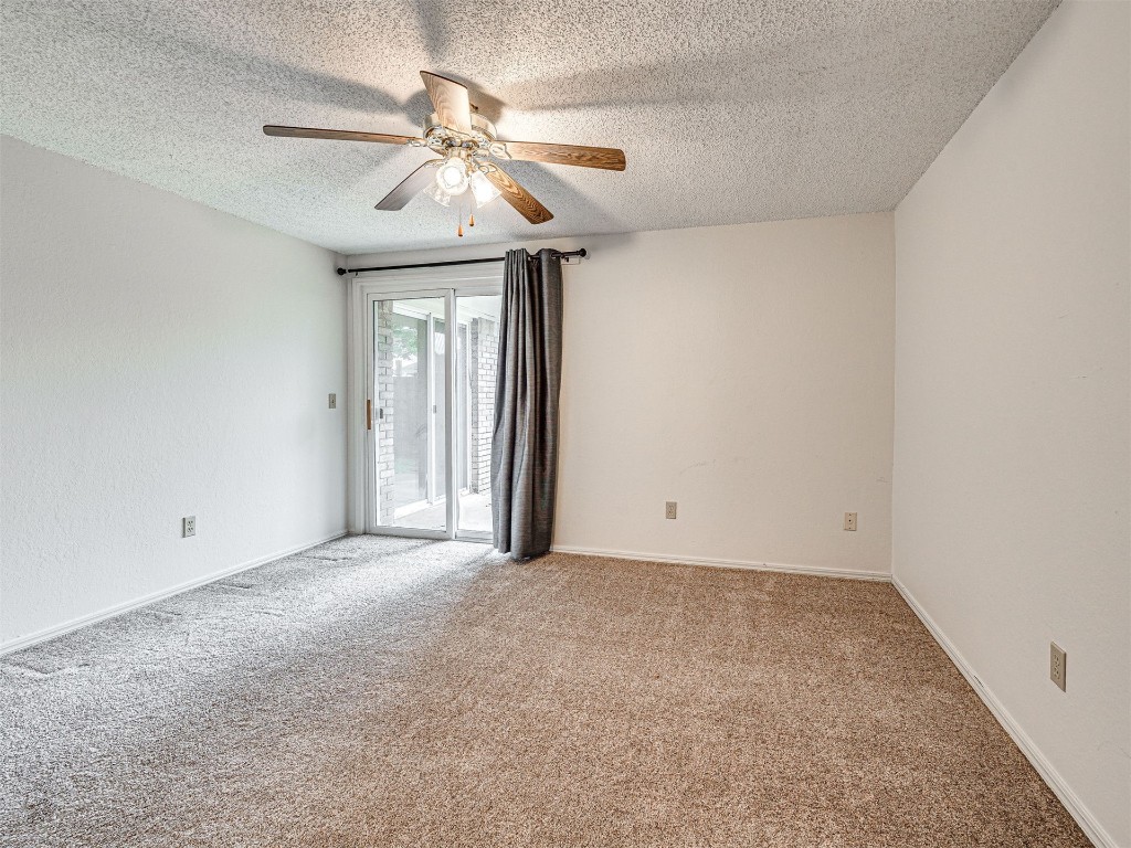 7613 NW 113th Place, Oklahoma City, OK 73162 unfurnished room with a textured ceiling, ceiling fan, and carpet