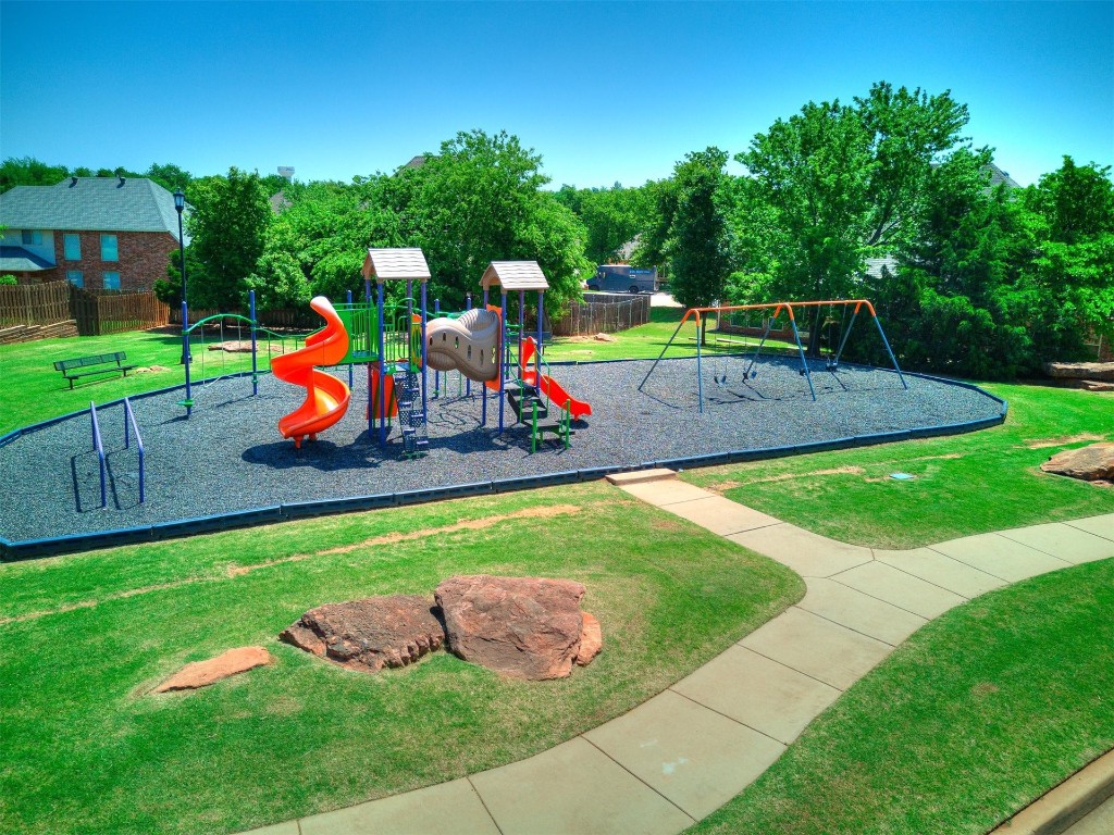 749 Gallant Fox Court, Edmond, OK 73025 view of jungle gym featuring a lawn