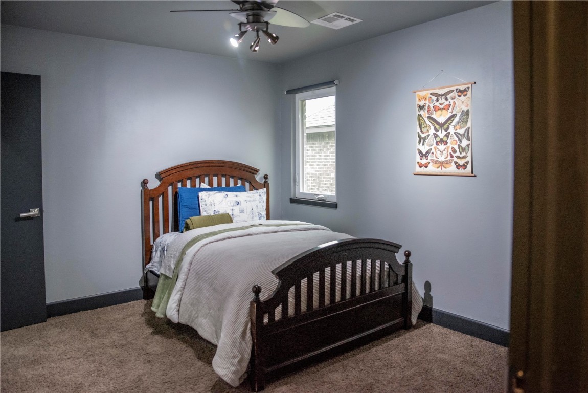 17308 Shadow Hawk Lane, Edmond, OK 73012 carpeted bedroom featuring ceiling fan