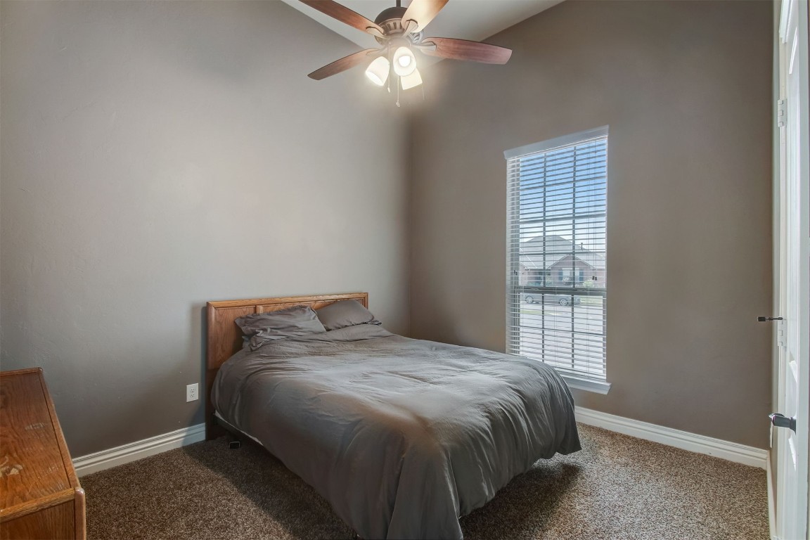 2816 Indian Grass Court, Edmond, OK 73013 carpeted bedroom with ceiling fan