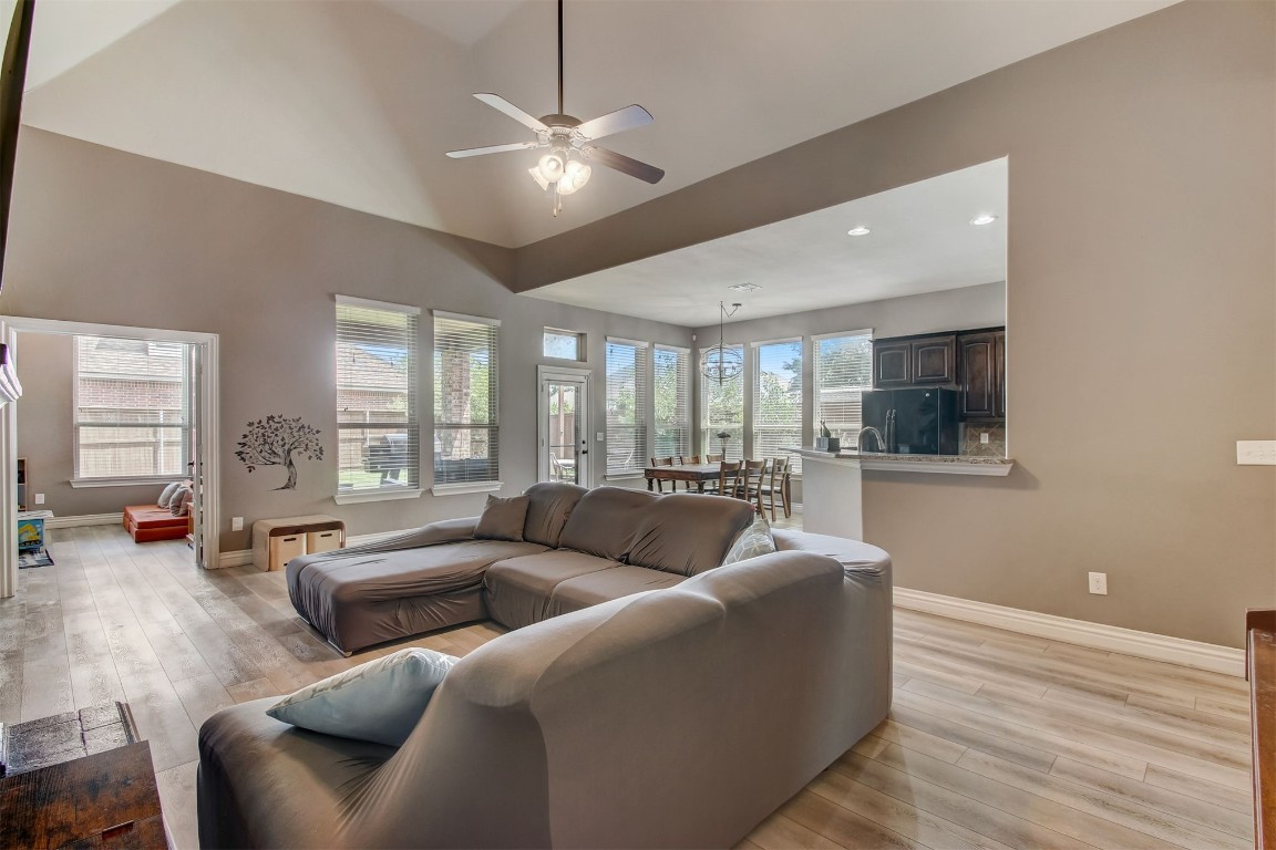 2816 Indian Grass Court, Edmond, OK 73013 living room with light hardwood / wood-style floors, a healthy amount of sunlight, and ceiling fan