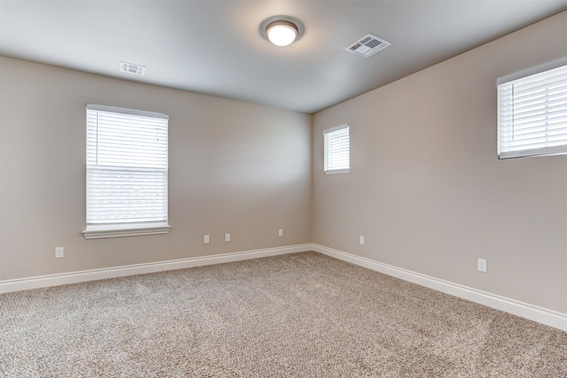10508 Glover River Drive, Yukon, OK 73099 unfurnished bedroom with carpet and a closet