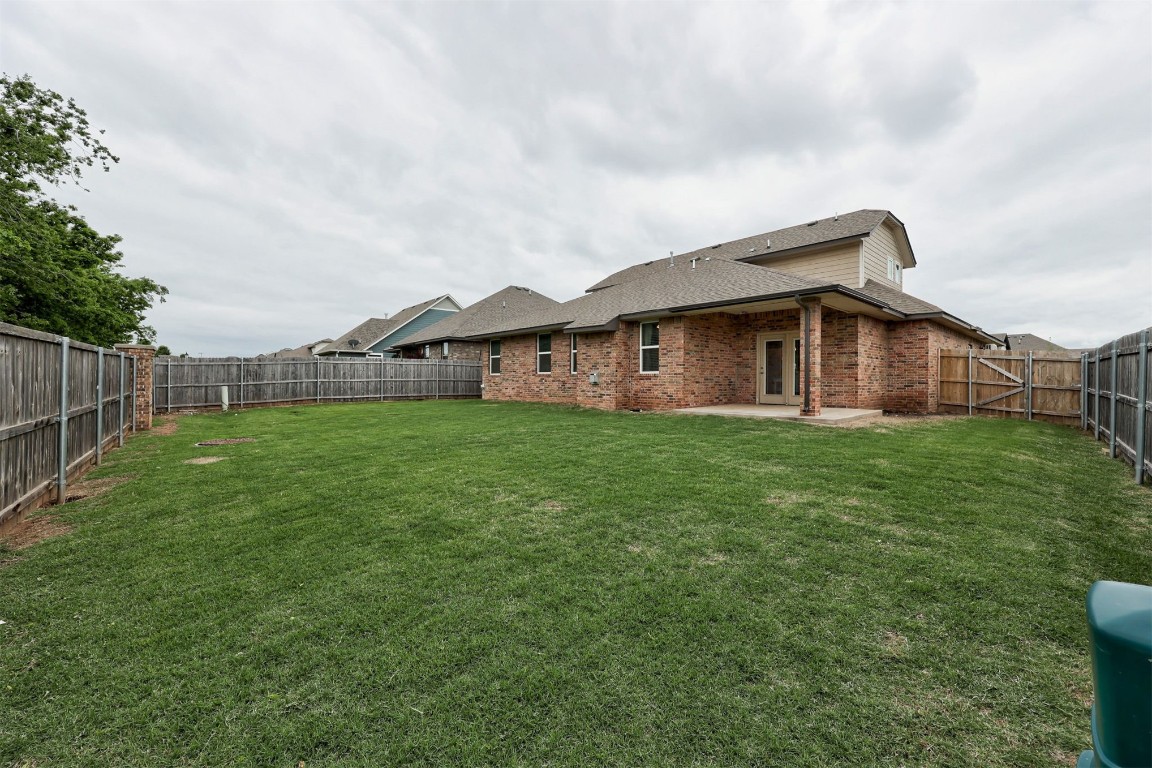 10508 Glover River Drive, Yukon, OK 73099 view of yard featuring a patio