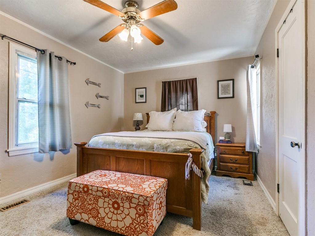 2505 NW 37th Place, Oklahoma City, OK 73112 bedroom with carpet, ceiling fan, a closet, and multiple windows