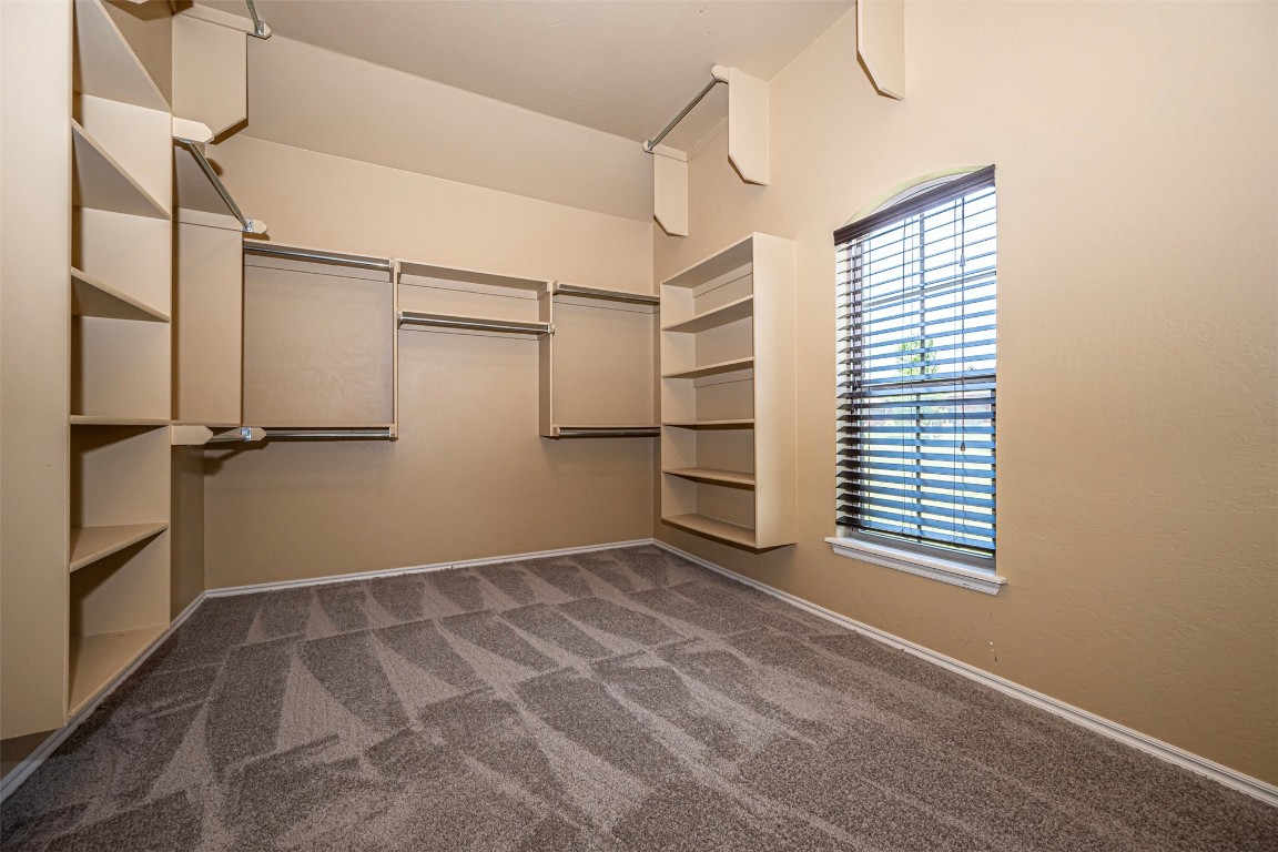 14509 Almond Valley Drive, Oklahoma City, OK 73165 spacious closet featuring dark carpet