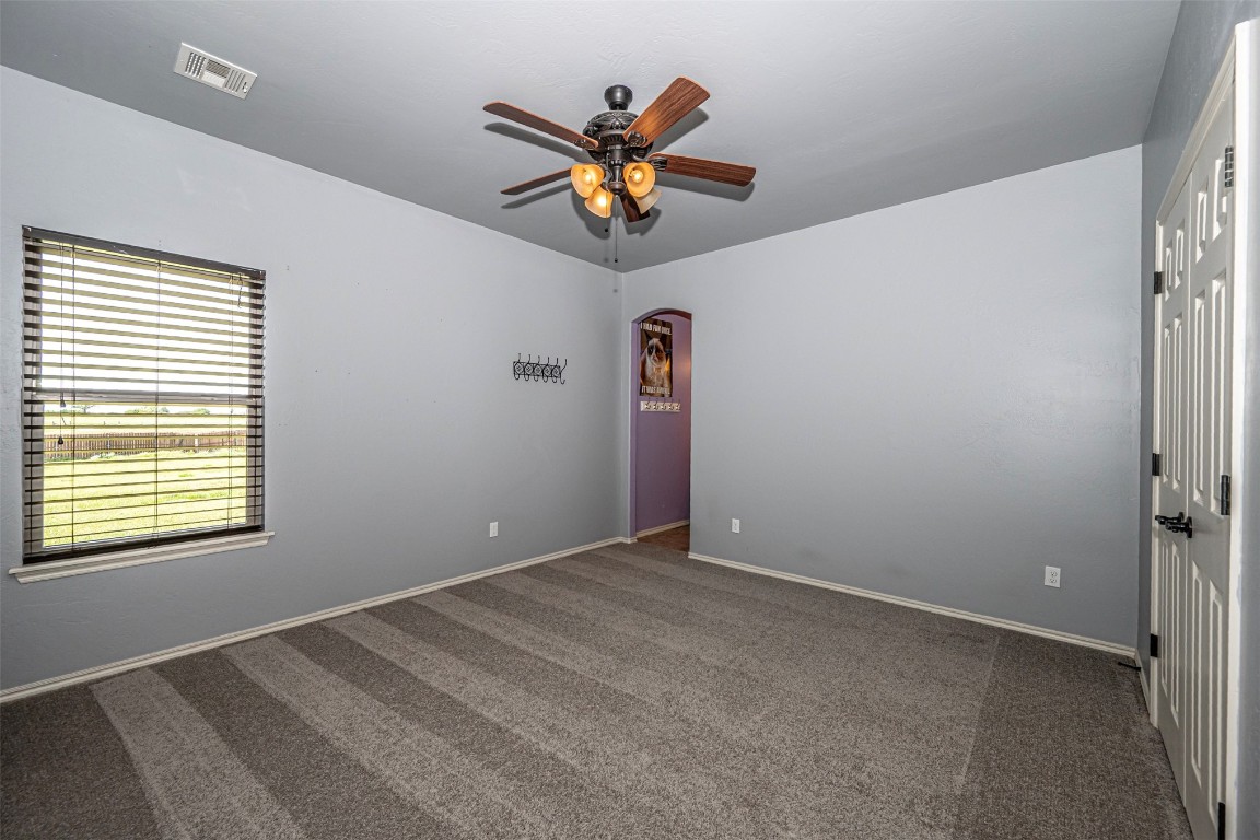 14509 Almond Valley Drive, Oklahoma City, OK 73165 unfurnished room featuring dark colored carpet and ceiling fan