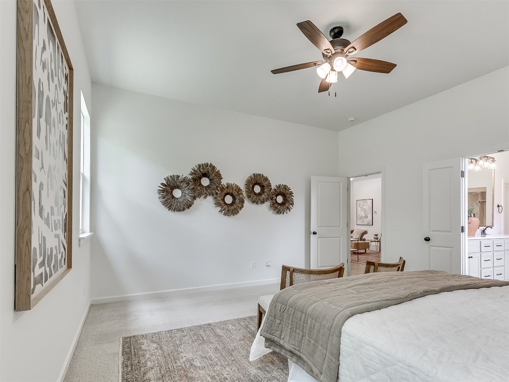 8007 Goldfinch Drive, Guthrie, OK 73044 bedroom featuring light carpet, connected bathroom, and ceiling fan