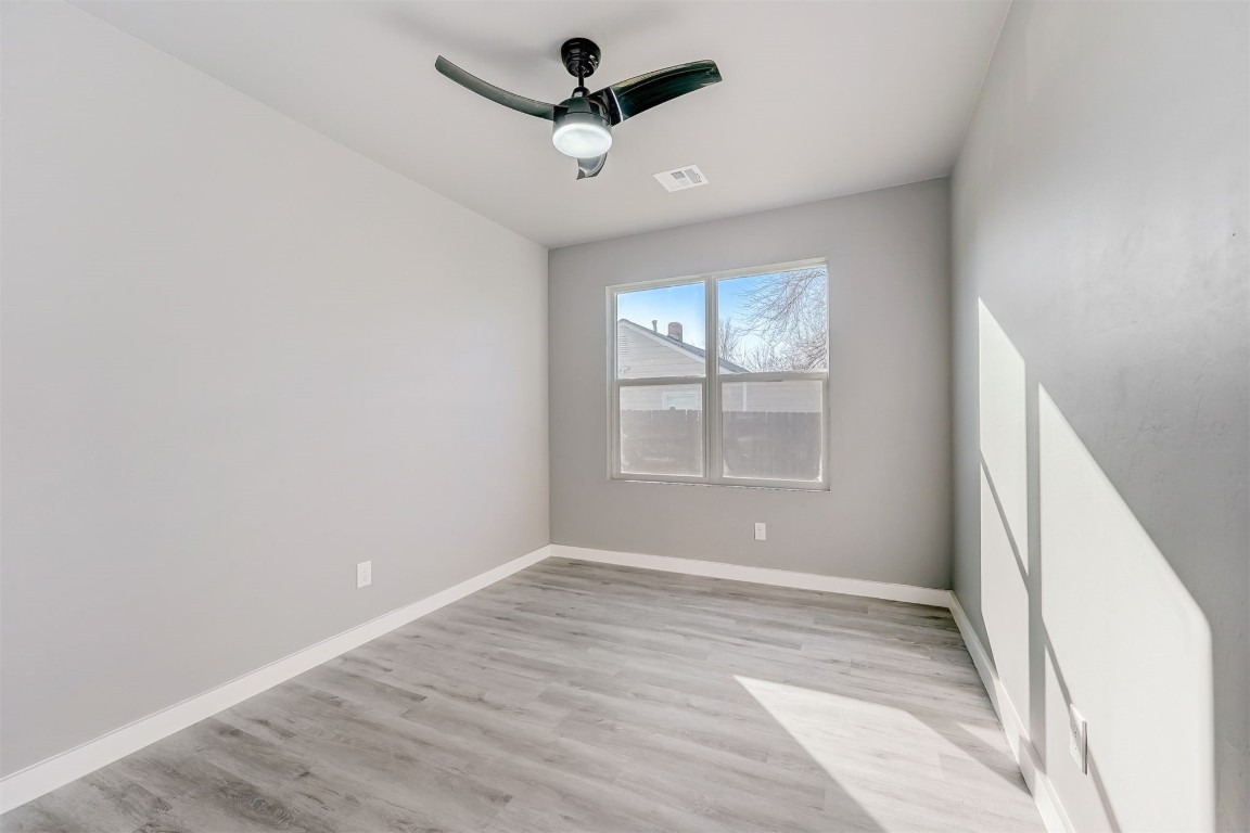1721 N Jordan Avenue, Oklahoma City, OK 73111 unfurnished room with light hardwood / wood-style floors and ceiling fan