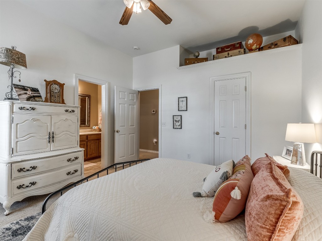 10621 Sundance Avenue, Yukon, OK 73099 tiled bedroom with ensuite bath and ceiling fan