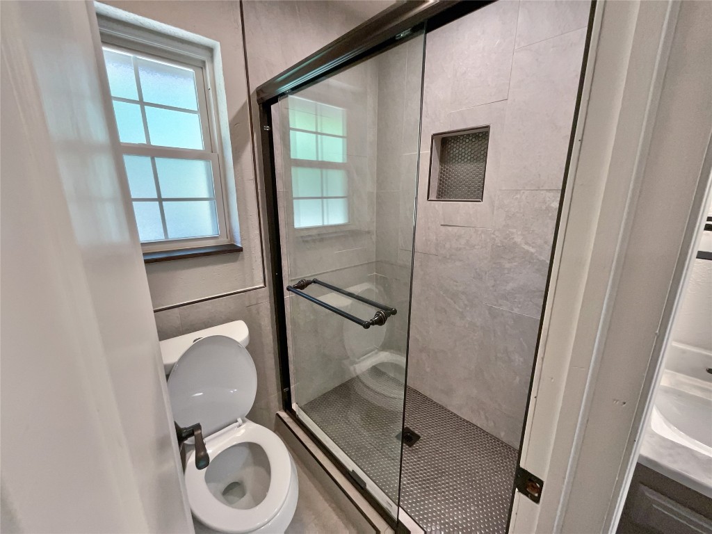 6645 Whitehall Drive, Oklahoma City, OK 73132 bathroom with an enclosed shower and toilet