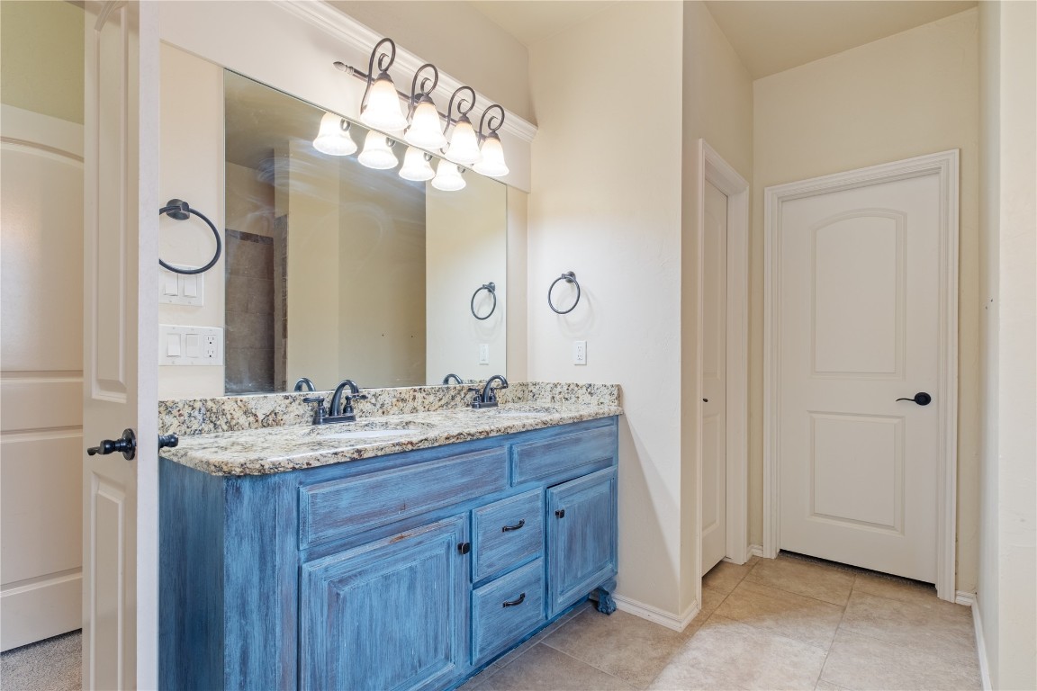 16209 Scissortail Drive, Edmond, OK 73013 bathroom featuring oversized vanity, tile floors, and double sink