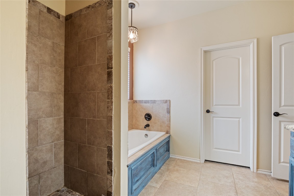16209 Scissortail Drive, Edmond, OK 73013 bathroom featuring tile floors and plus walk in shower