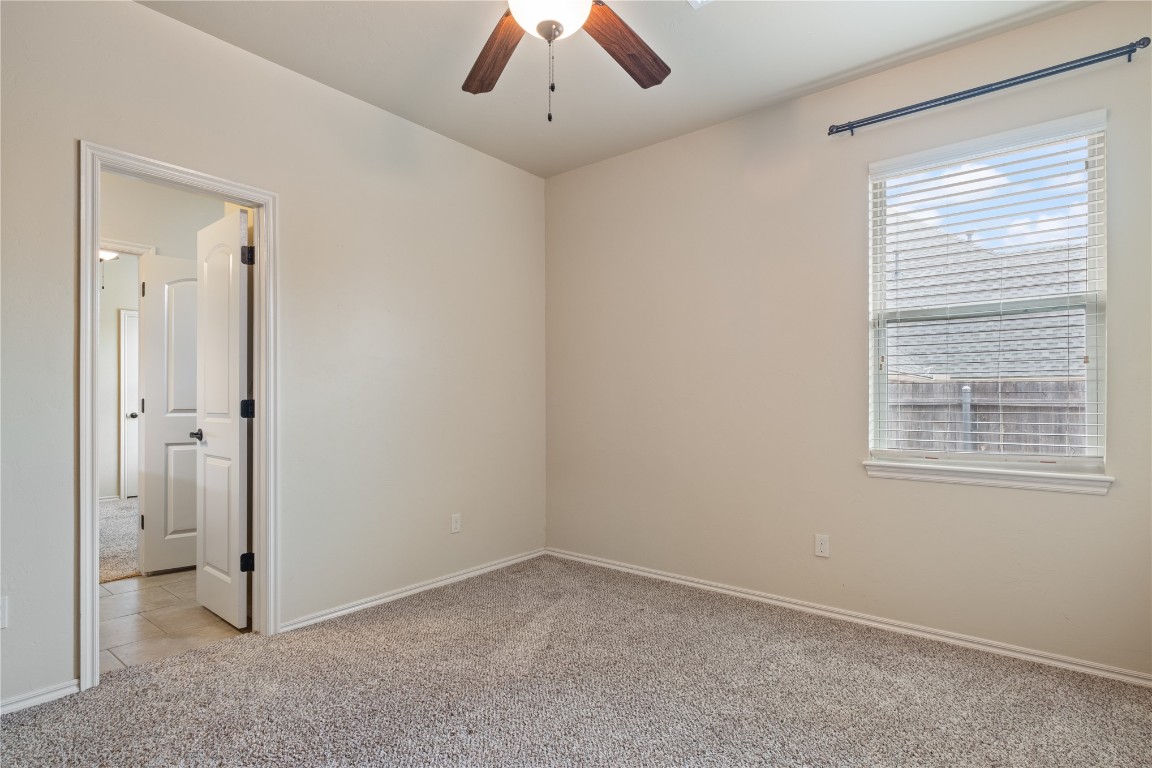 16209 Scissortail Drive, Edmond, OK 73013 unfurnished room with ceiling fan and light tile floors