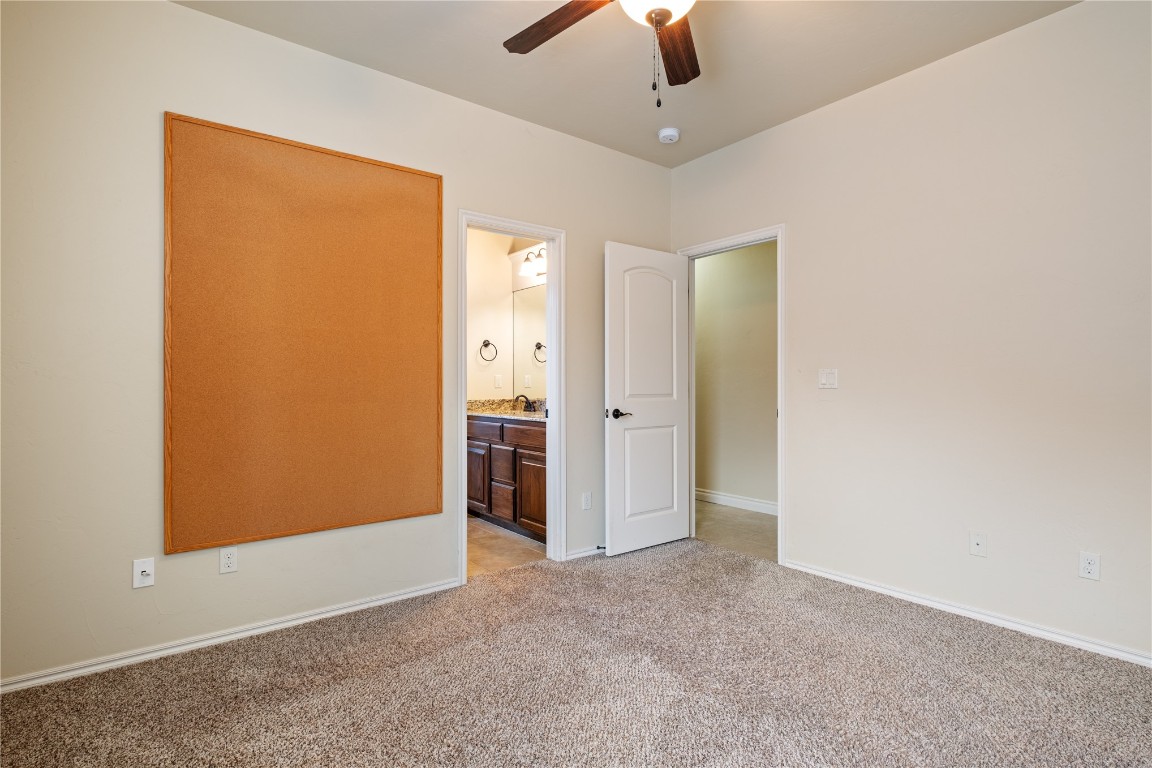 16209 Scissortail Drive, Edmond, OK 73013 carpeted spare room with ceiling fan