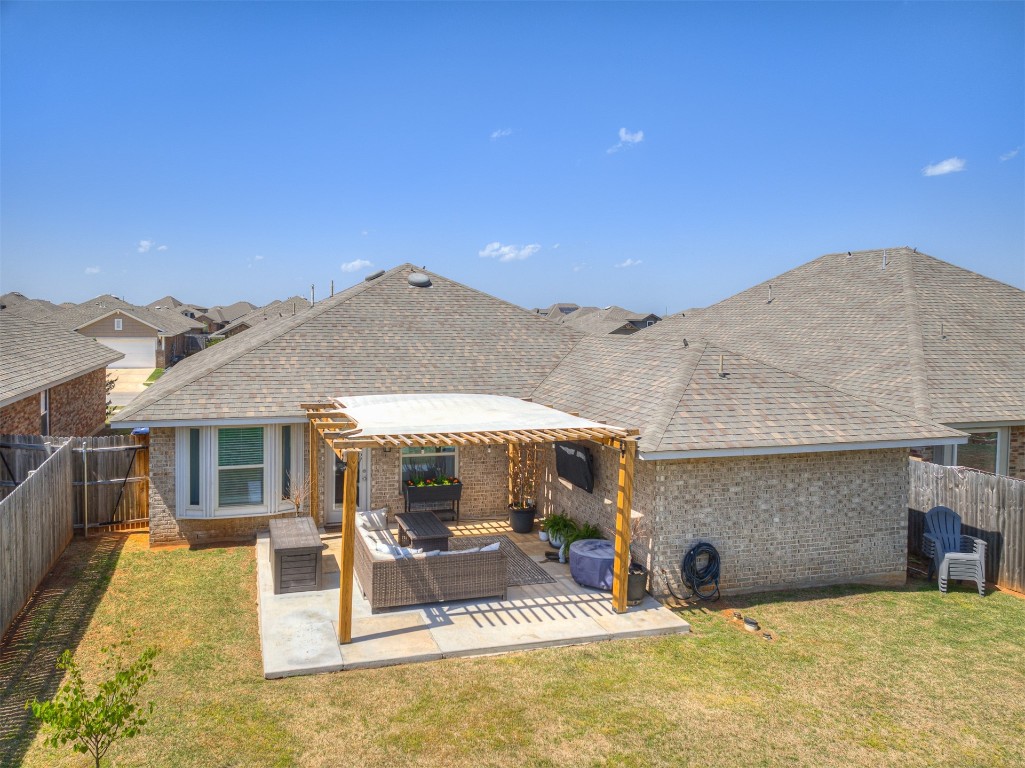 3008 NW 183rd Street, Edmond, OK 73012 rear view of property with a lawn, an outdoor living space, and a patio
