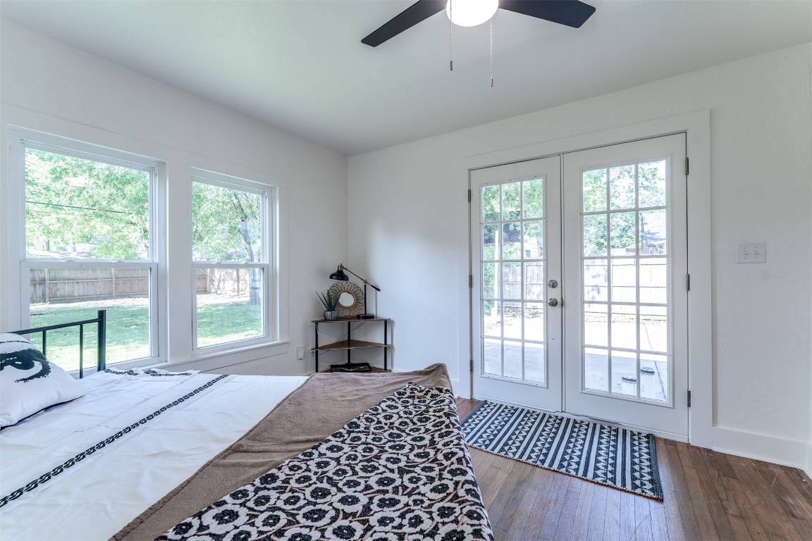 620 Nebraska Street, Norman, OK 73069 bedroom with dark wood-type flooring, ceiling fan, access to exterior, and multiple windows