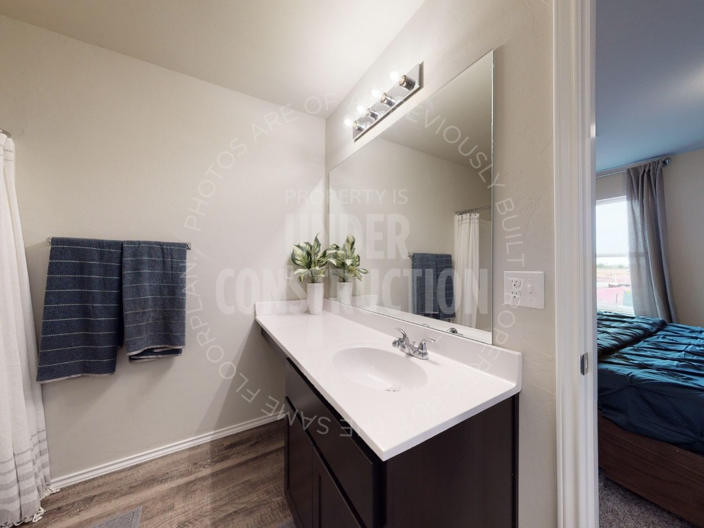 2203 W 31 Place, Stillwater, OK 74074 bathroom featuring hardwood / wood-style floors and large vanity