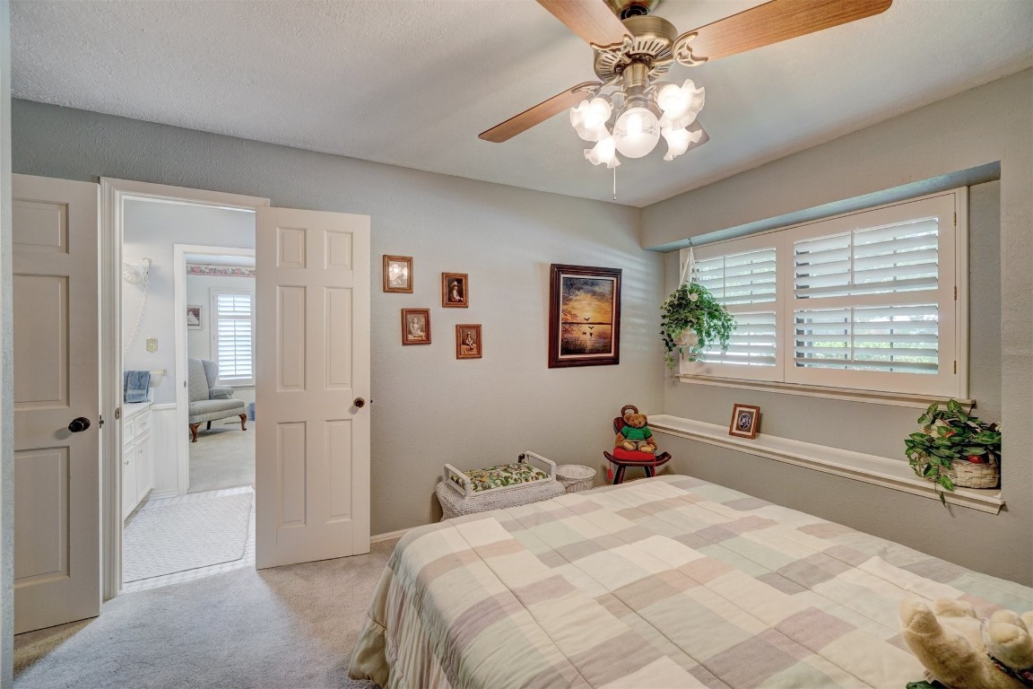 1707 Northcliff Avenue, Norman, OK 73071 bedroom with light colored carpet and ceiling fan