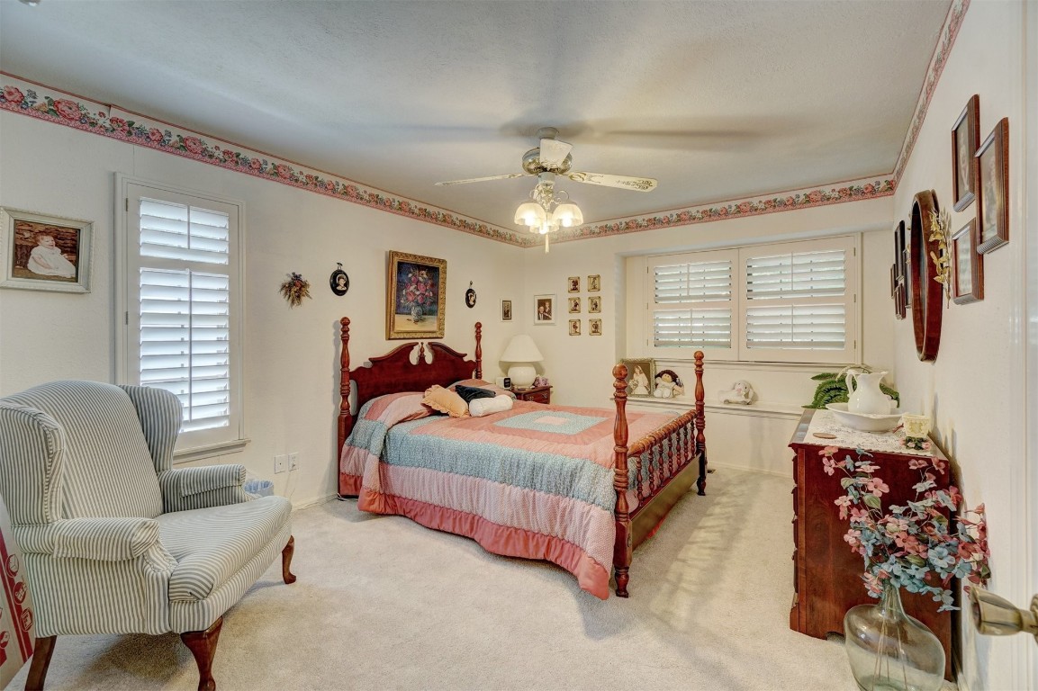 1707 Northcliff Avenue, Norman, OK 73071 carpeted bedroom featuring ceiling fan and multiple windows