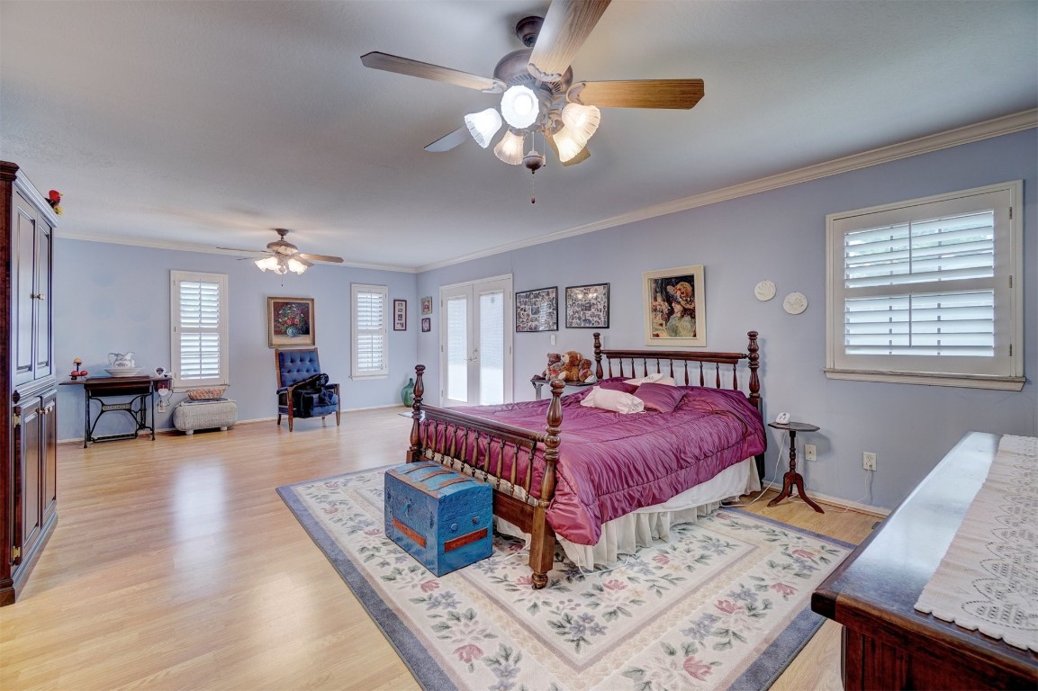 1707 Northcliff Avenue, Norman, OK 73071 bedroom featuring crown molding, light hardwood / wood-style flooring, and multiple windows