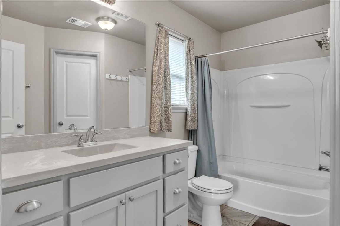 19101 Visto Drive, Edmond, OK 73012 full bathroom with oversized vanity, shower / tub combo, toilet, and tile flooring