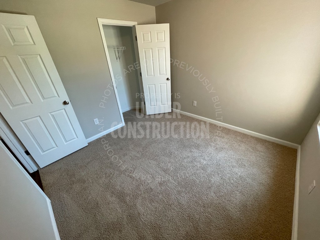 1202 Foal Drive, Guthrie, OK 73044 unfurnished bedroom with a closet and carpet flooring