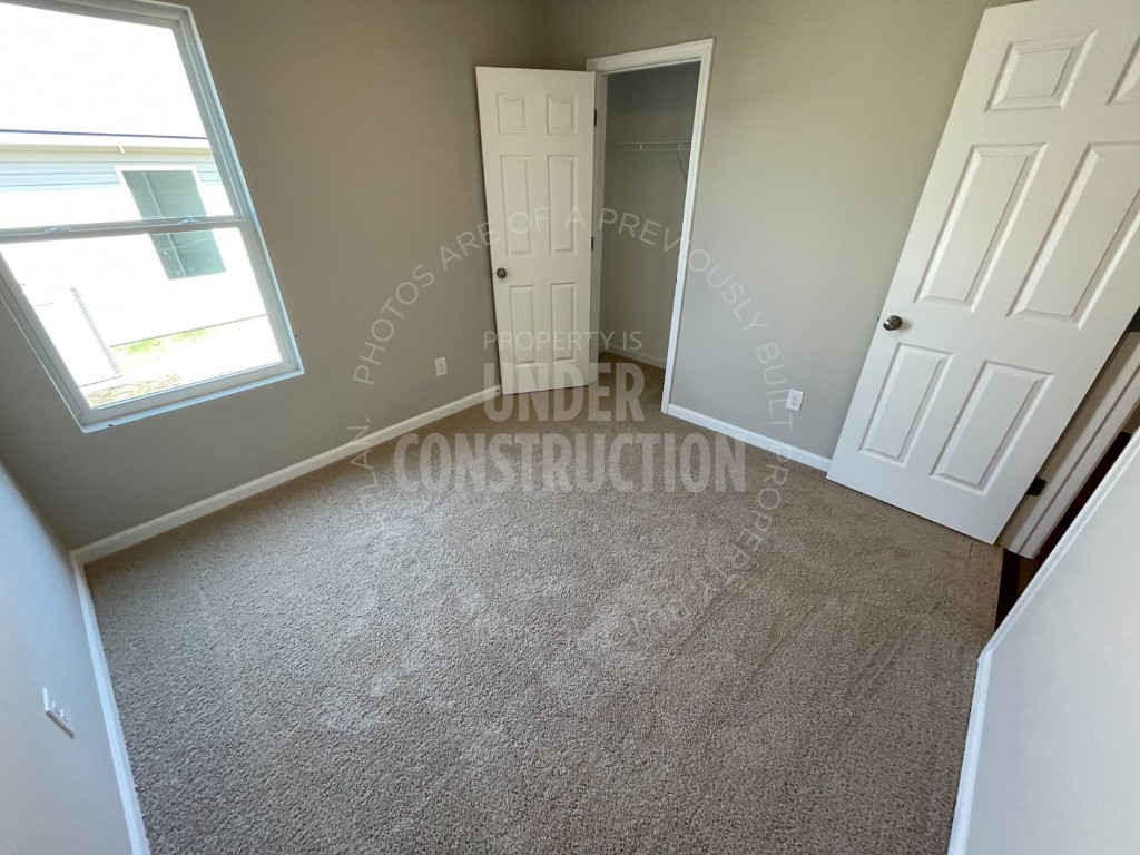 1202 Foal Drive, Guthrie, OK 73044 unfurnished bedroom with a closet and carpet floors