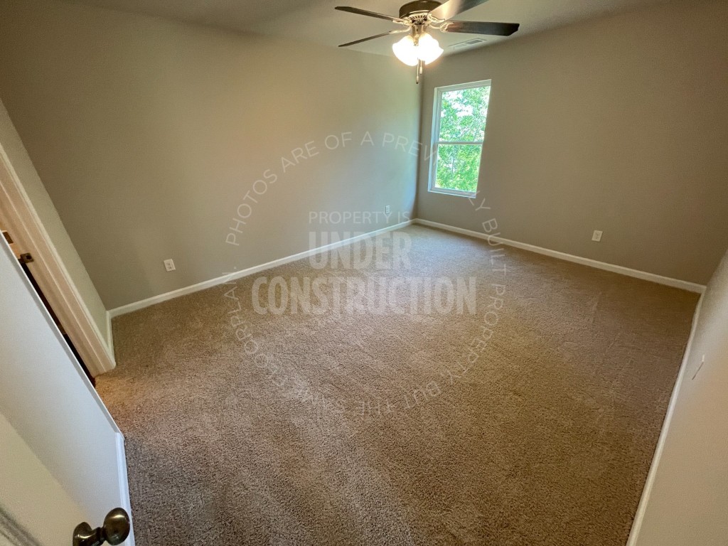 1202 Foal Drive, Guthrie, OK 73044 empty room with ceiling fan and carpet