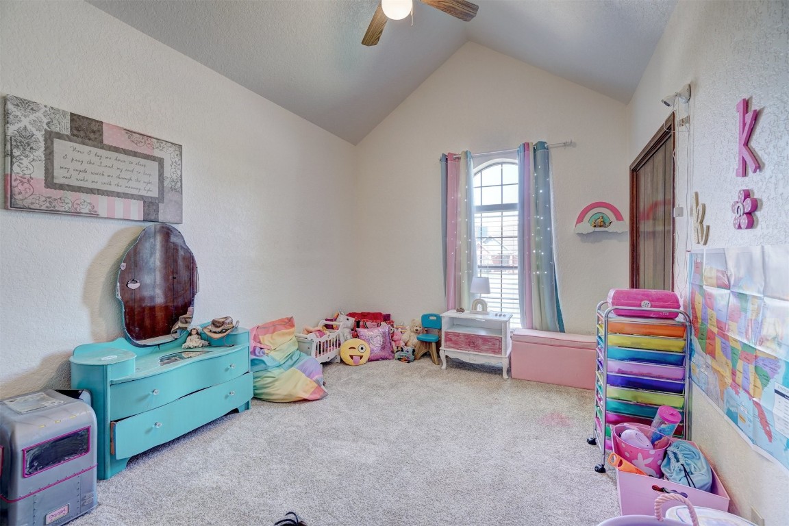 1816 NW 176th Street, Edmond, OK 73012 playroom featuring lofted ceiling, ceiling fan, and carpet flooring