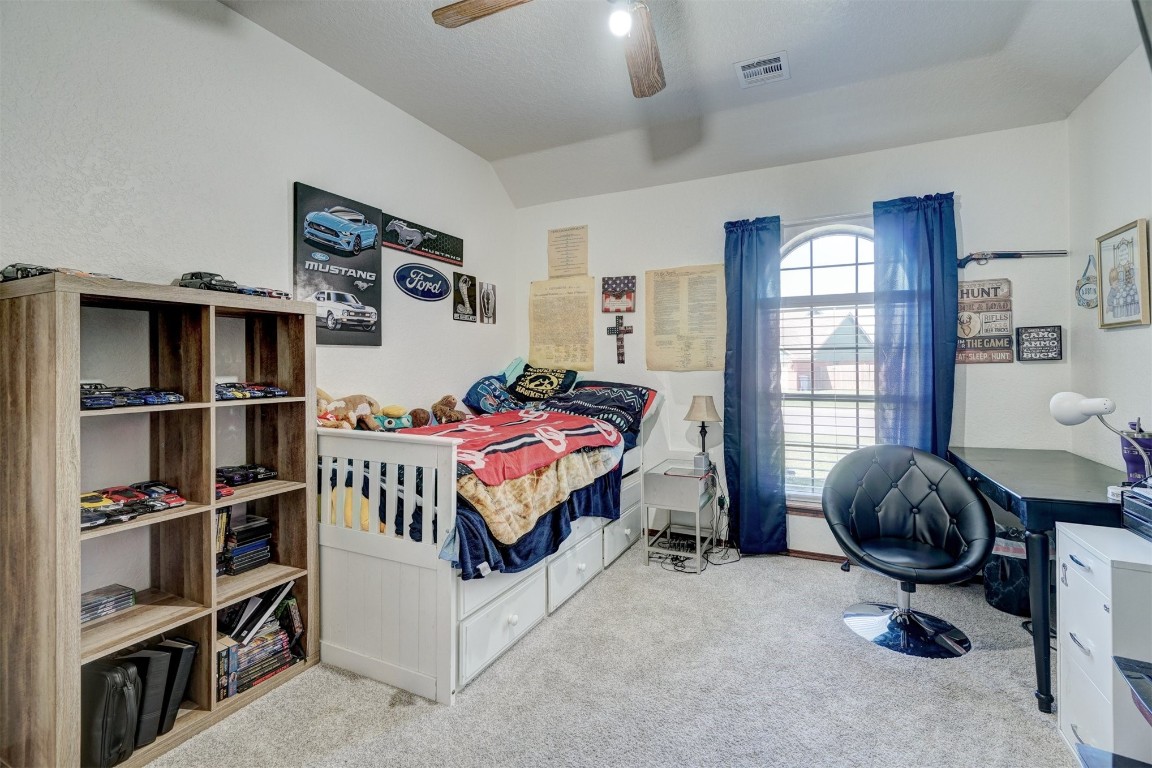 1816 NW 176th Street, Edmond, OK 73012 bedroom featuring light colored carpet and ceiling fan