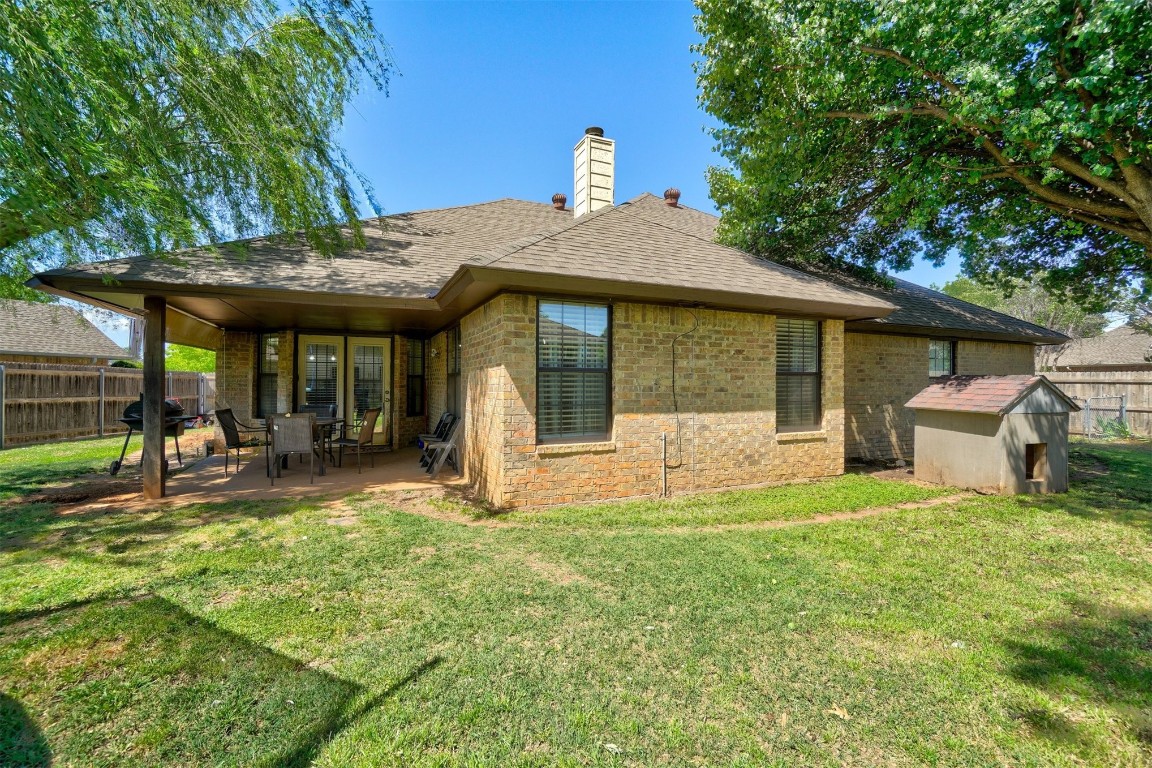 1816 NW 176th Street, Edmond, OK 73012 back of house featuring a patio, a storage shed, and a yard