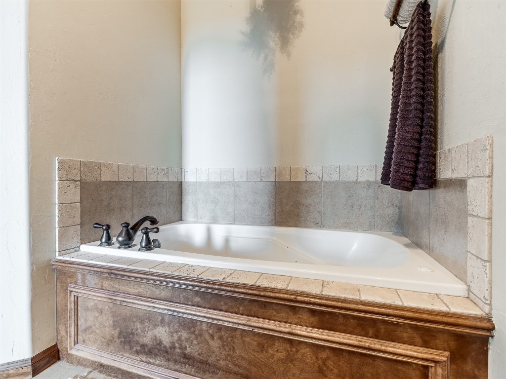 10521 NW 49th Street, Yukon, OK 73099 bathroom with a relaxing tiled bath