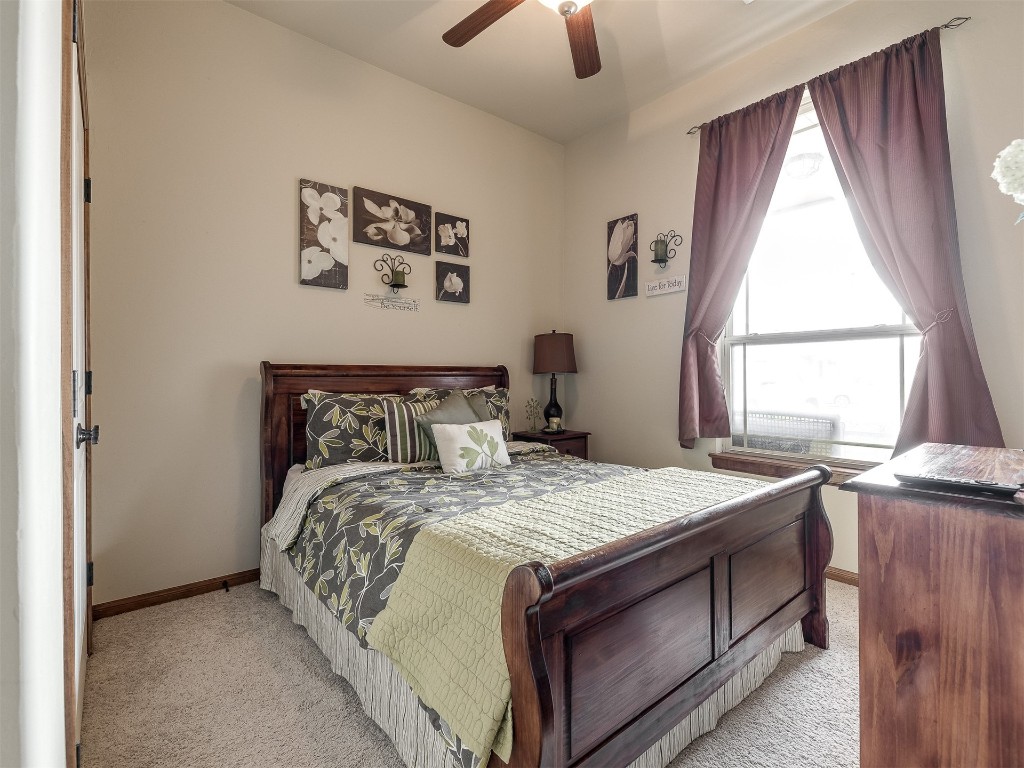 10521 NW 49th Street, Yukon, OK 73099 carpeted bedroom with ceiling fan