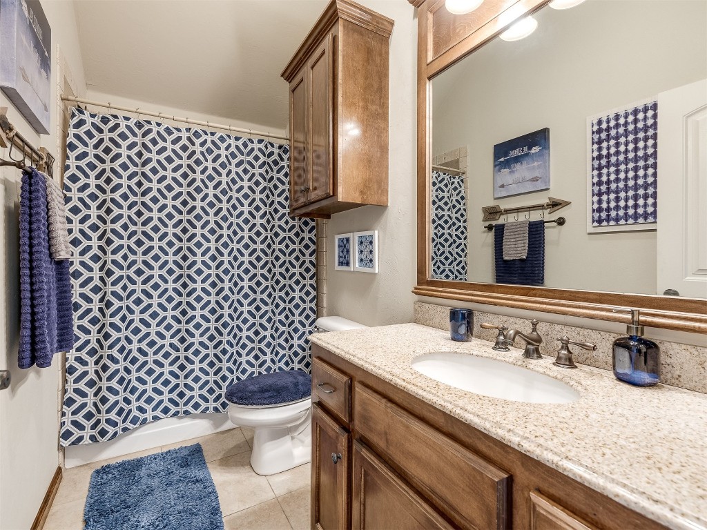 10521 NW 49th Street, Yukon, OK 73099 bathroom featuring tile flooring, vanity, and toilet