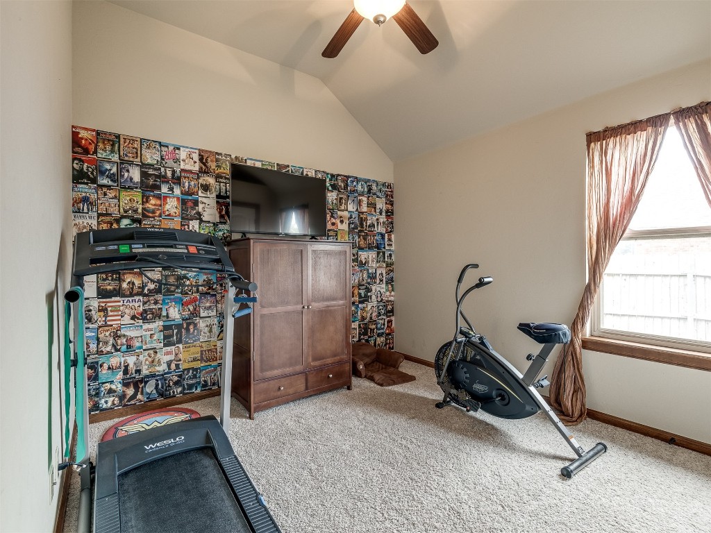 10521 NW 49th Street, Yukon, OK 73099 workout room featuring carpet, ceiling fan, and lofted ceiling