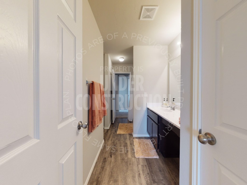 10024 SW 41st Street, Mustang, OK 73064 bathroom with wood-type flooring and vanity