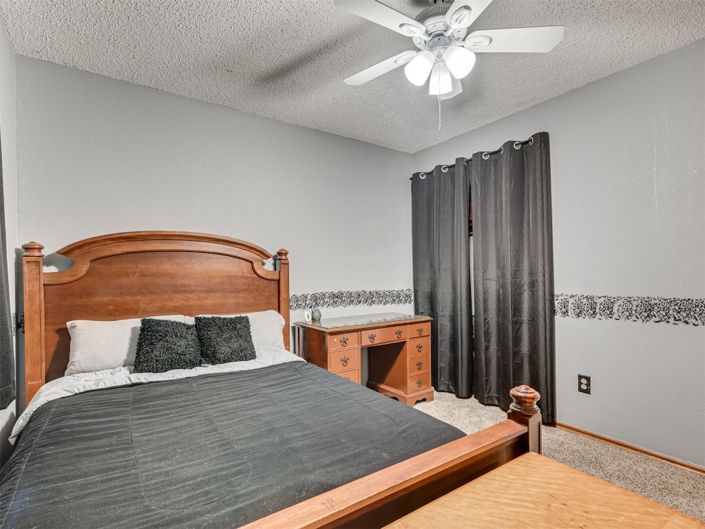 708 Waterview Road, Oklahoma City, OK 73170 carpeted bedroom featuring ceiling fan and a textured ceiling