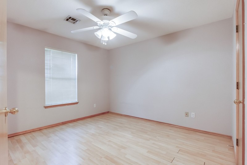 2708 NW 161st Street, Edmond, OK 73013 unfurnished room with ceiling fan and light wood-type flooring