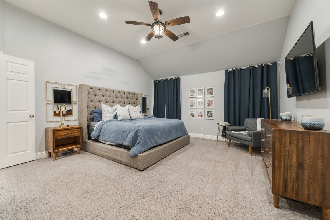 11512 Devonbrook Court, Midwest City, OK 73130 carpeted bedroom with vaulted ceiling and ceiling fan