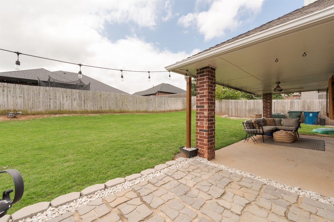 11512 Devonbrook Court, Midwest City, OK 73130 view of yard featuring ceiling fan and a patio area
