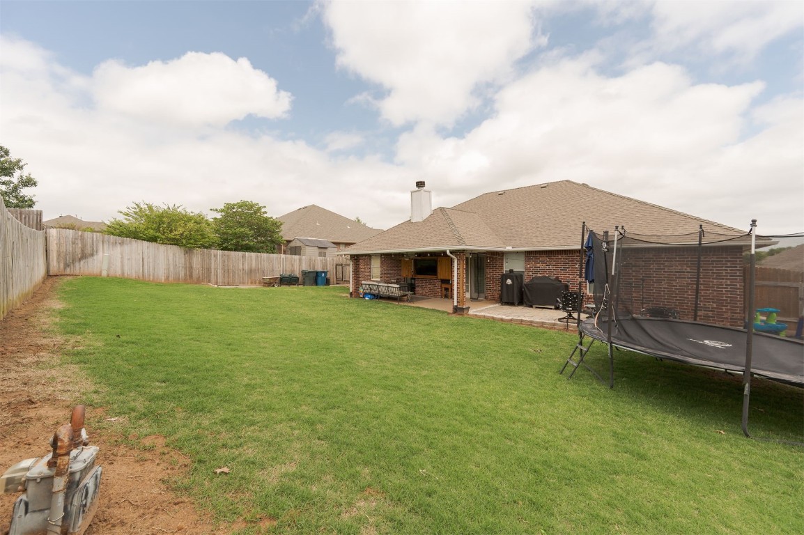 11512 Devonbrook Court, Midwest City, OK 73130 view of yard with a trampoline and a patio