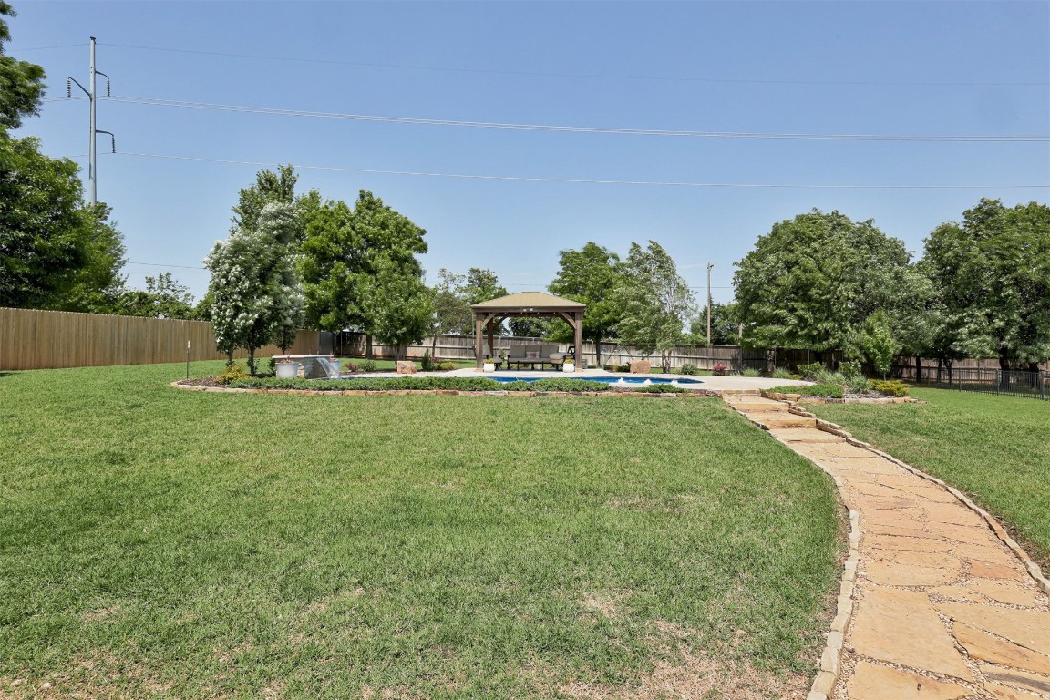 11125 London Circle, Arcadia, OK 73007 view of yard with a fenced in pool and a gazebo