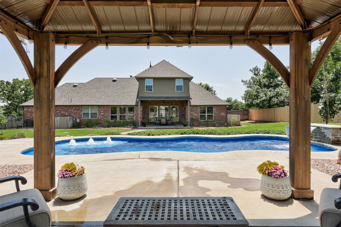 11125 London Circle, Arcadia, OK 73007 view of pool featuring pool water feature, a gazebo, and a patio