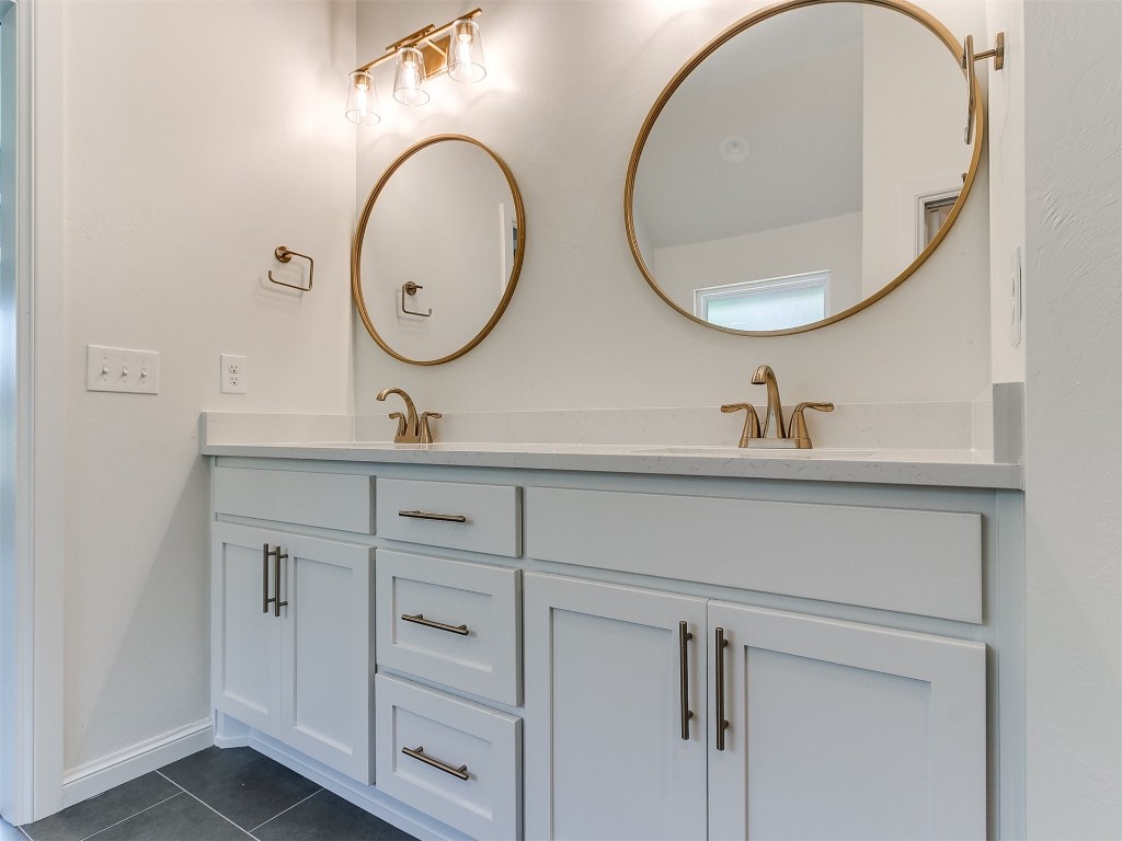10440 SW 51 Street, Mustang, OK 73064 bathroom featuring tile floors and double sink vanity