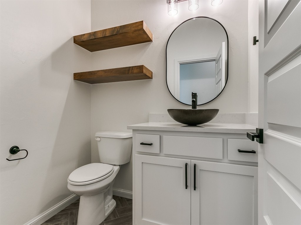10440 SW 51 Street, Mustang, OK 73064 bathroom featuring toilet, vanity, and parquet floors