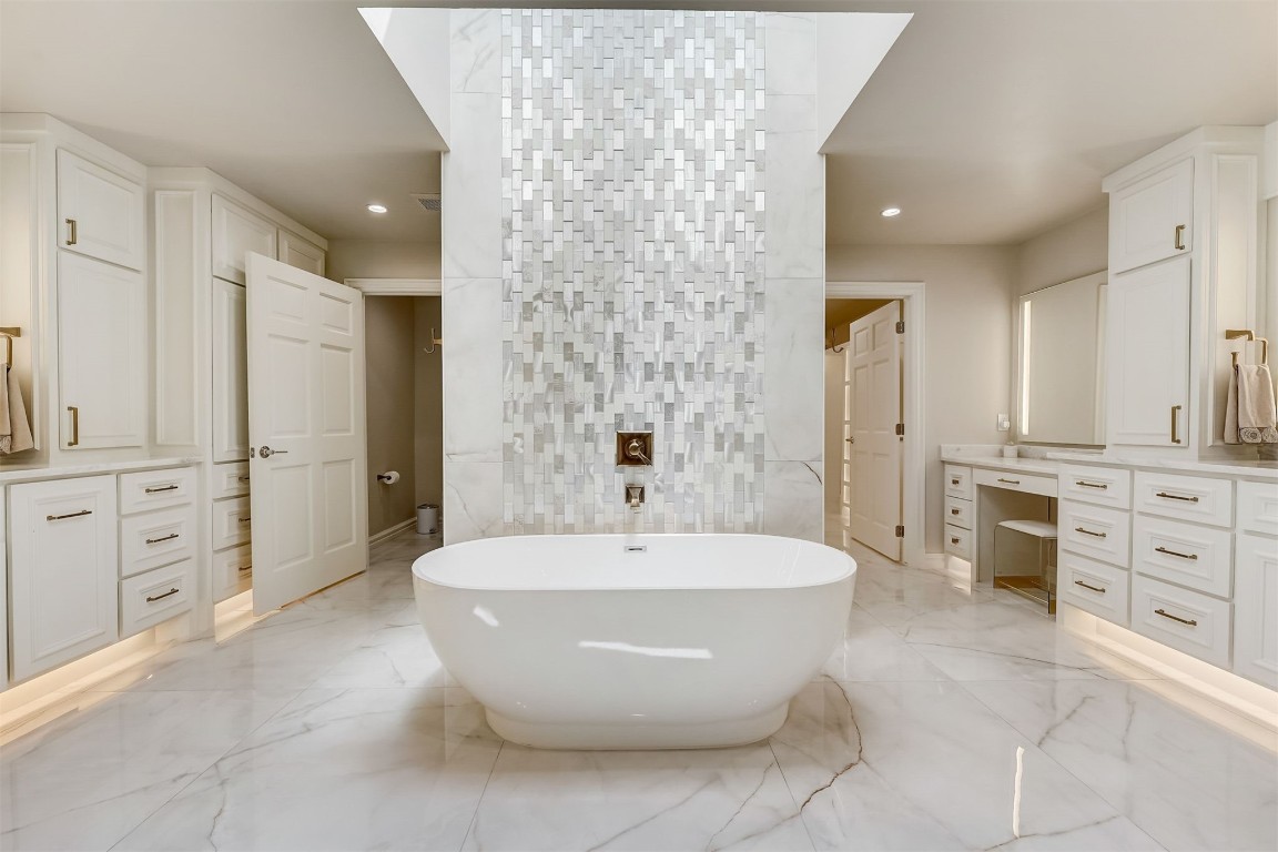 5220 NE 131st Court, Edmond, OK 73013 bathroom with tile walls, oversized vanity, tile floors, and a bathtub