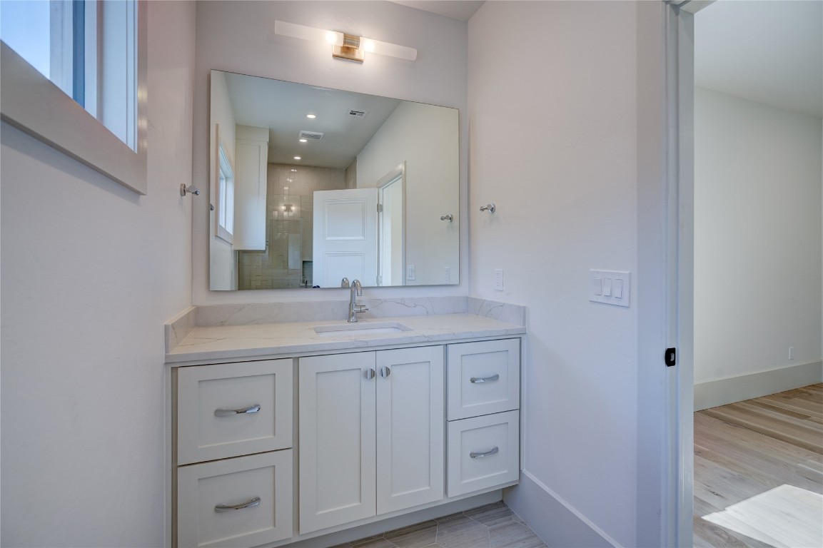 908 NW 44th Street, Oklahoma City, OK 73118 bathroom featuring hardwood / wood-style floors and oversized vanity