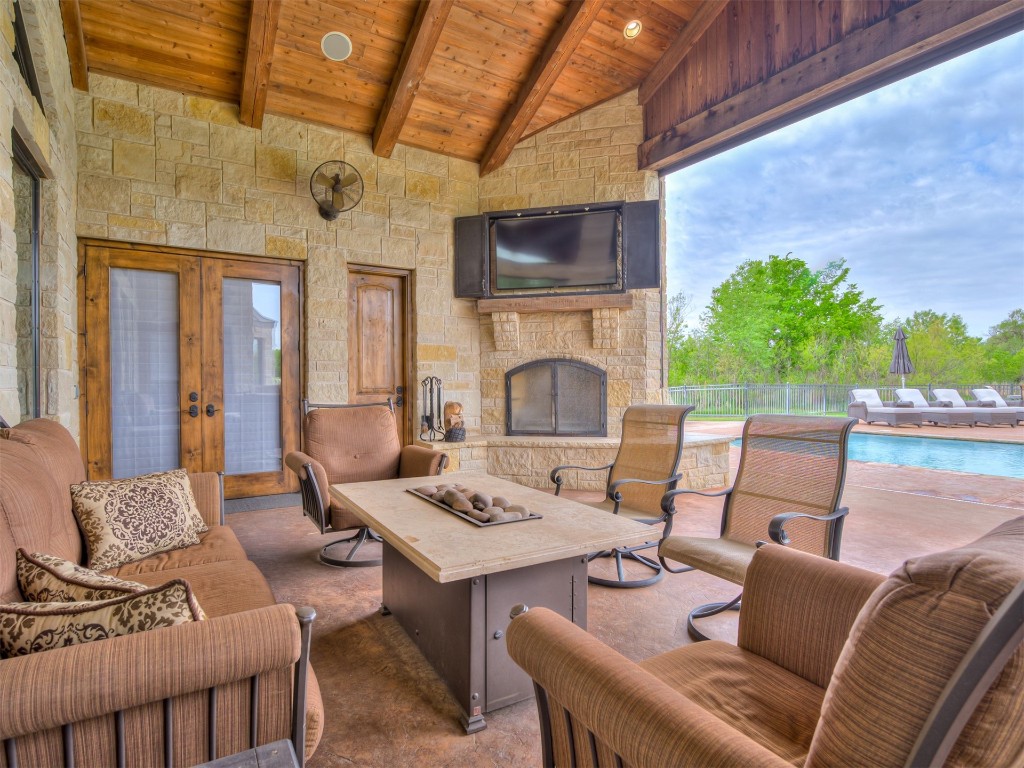 713 N 76 Highway, Newcastle, OK 73065 view of patio with an outdoor stone fireplace and a fenced in pool